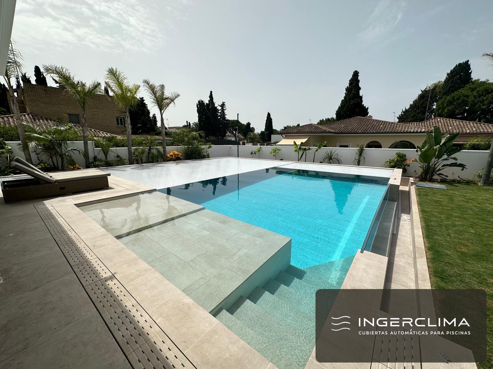 Automatic cover half open over an infinity pool: half the water covered, half open