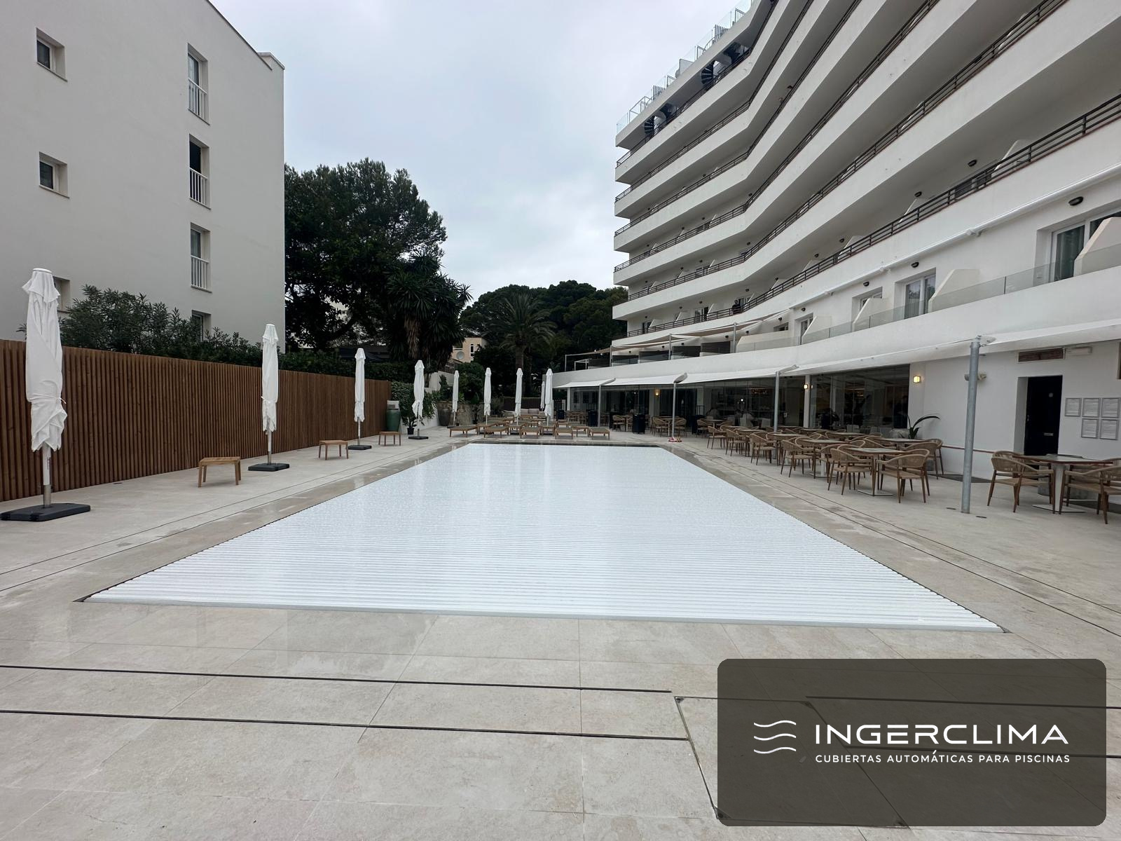 Automatic cover closed over the long pool of a hotel